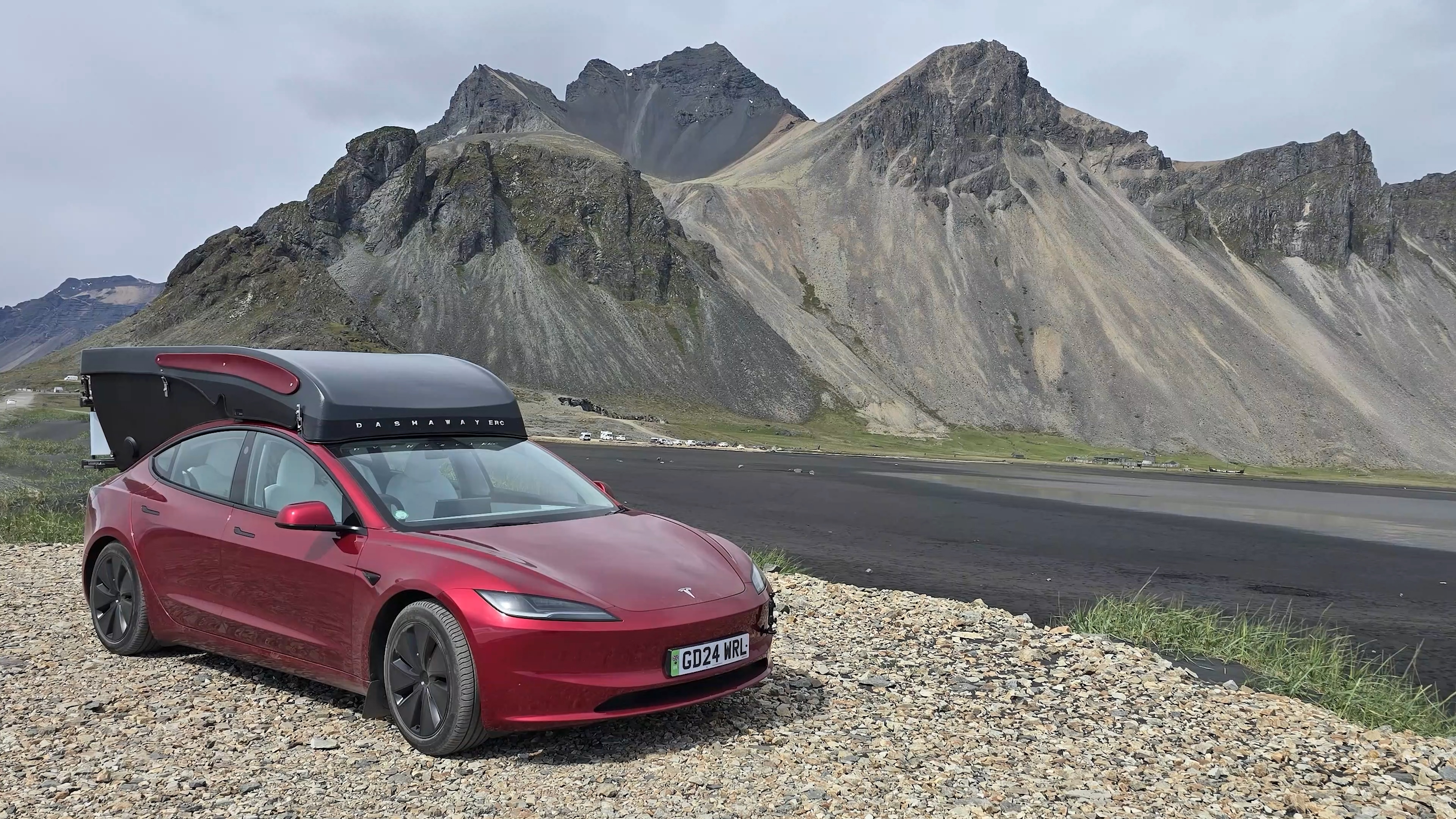 Tesla with roof camper in front of Vestrahorn mountain, Iceland