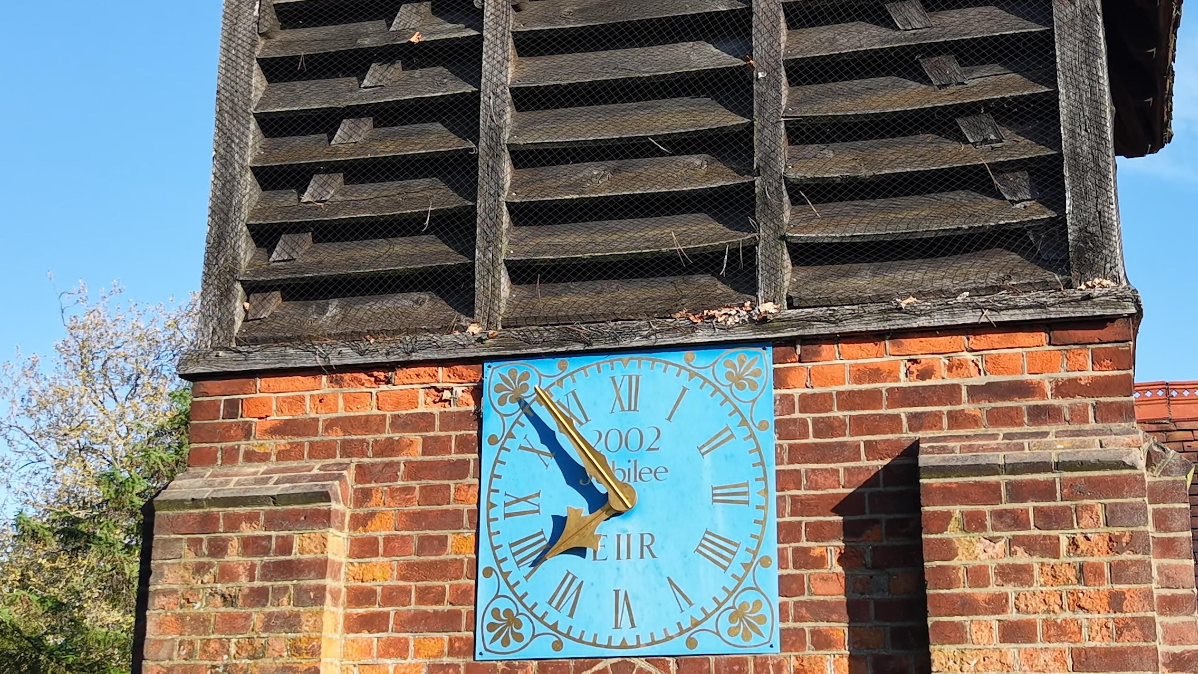 Drone close-up of degraded brickwork and clock tower showing deterioration