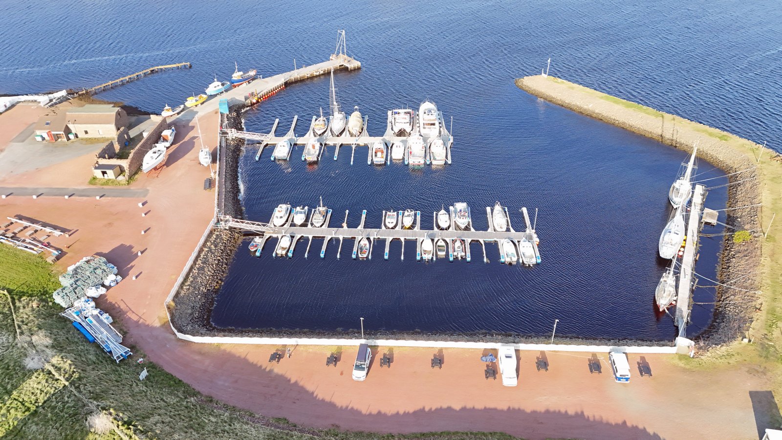 Aerial drone view of Skeld marina with boats moored in Shetland