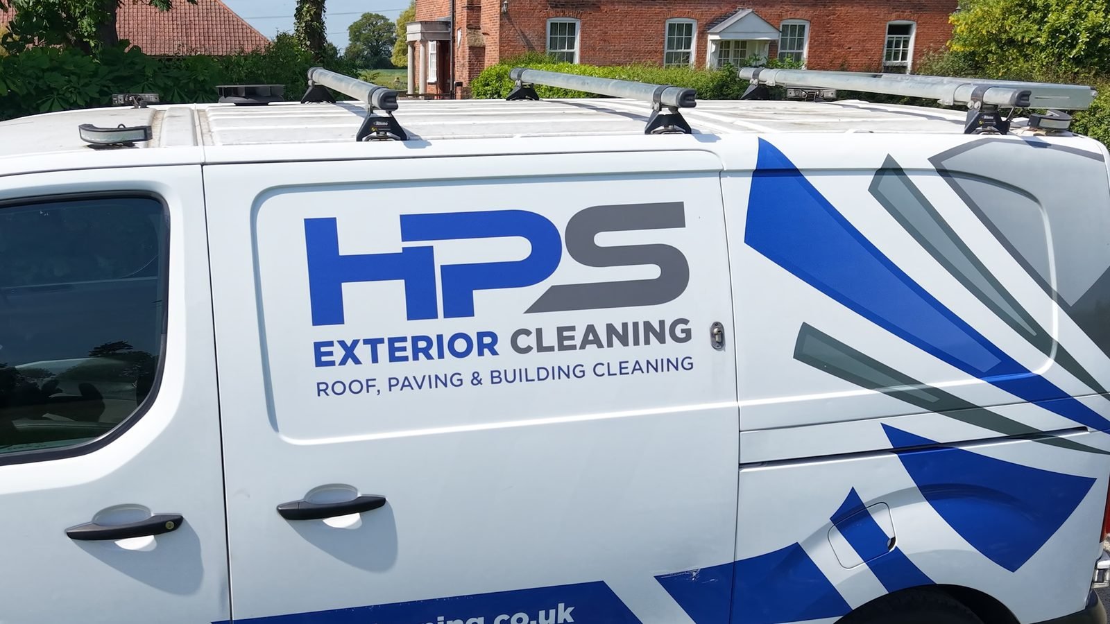 Drone tracking shot of HPS Exterior Cleaning branded van on rural Essex road