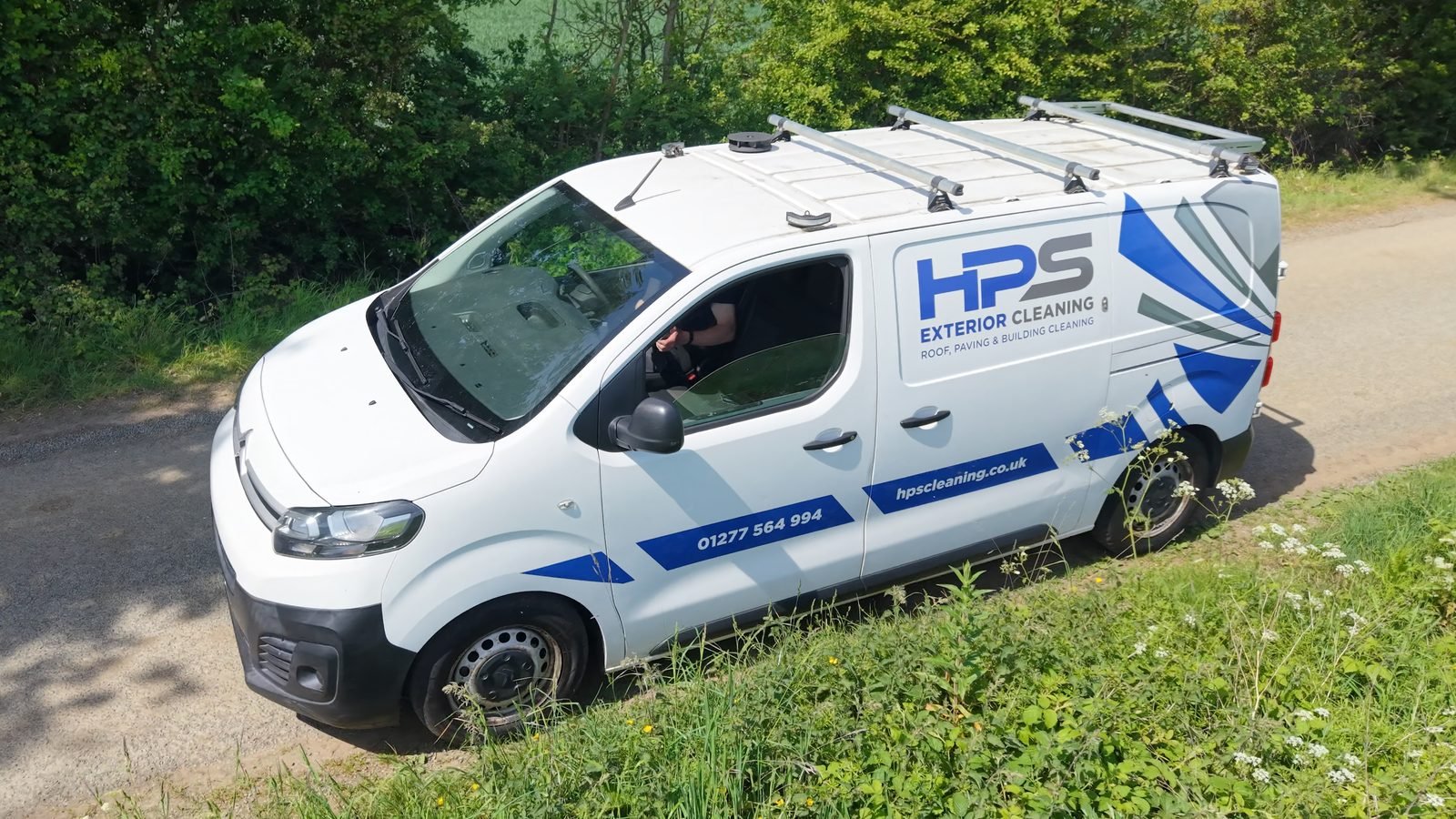 Aerial drone shot of HPS Exterior Cleaning van parked on country lane