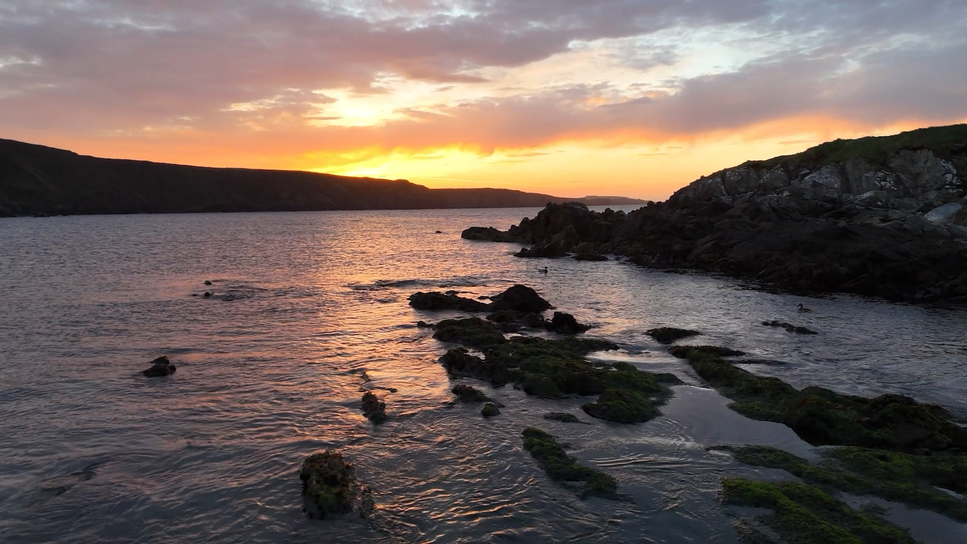 Drone sunset over rocky coastline on Unst, Shetland