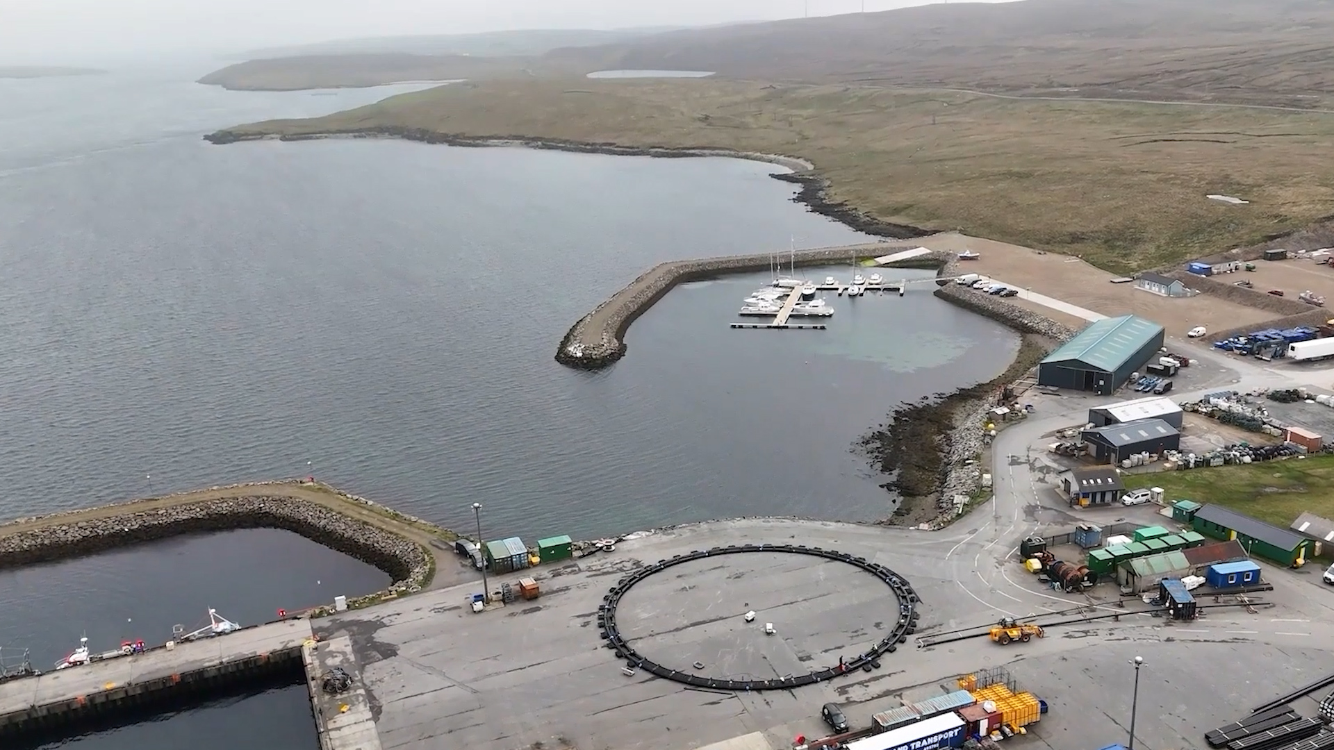 Wide aerial drone view of harbour, marina and infrastructure on Yell, Shetland